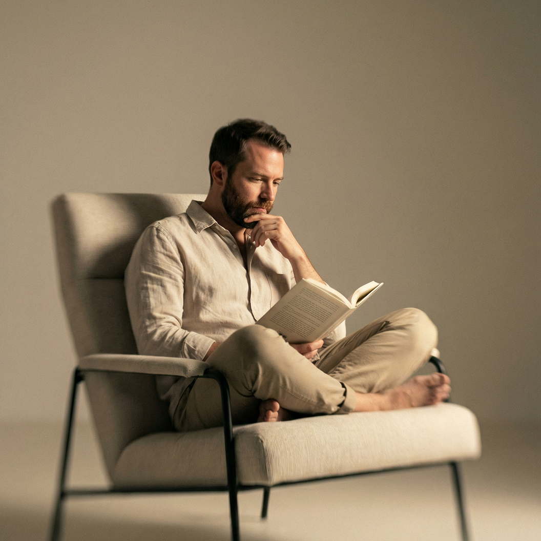 A man reading in a chair